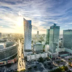 Widok na nowoczesne centrum Warszawy o zachodzie słońca. Marzenie o studiach w Warszawie staje się rzeczywistością wśród tych drapaczy chmur.